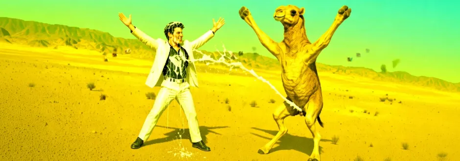 Thomas and a camel in the desert, being sprayed with cream